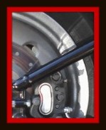 Rear wheel of motorcycle showing blocked section of frame to be detailed by Fifty Dollar Detail.